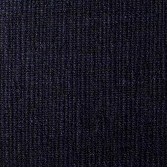 Indigo fabric texture displays a vertical rib weave with heathered tones, dense raised surface, and consistent linear structure.